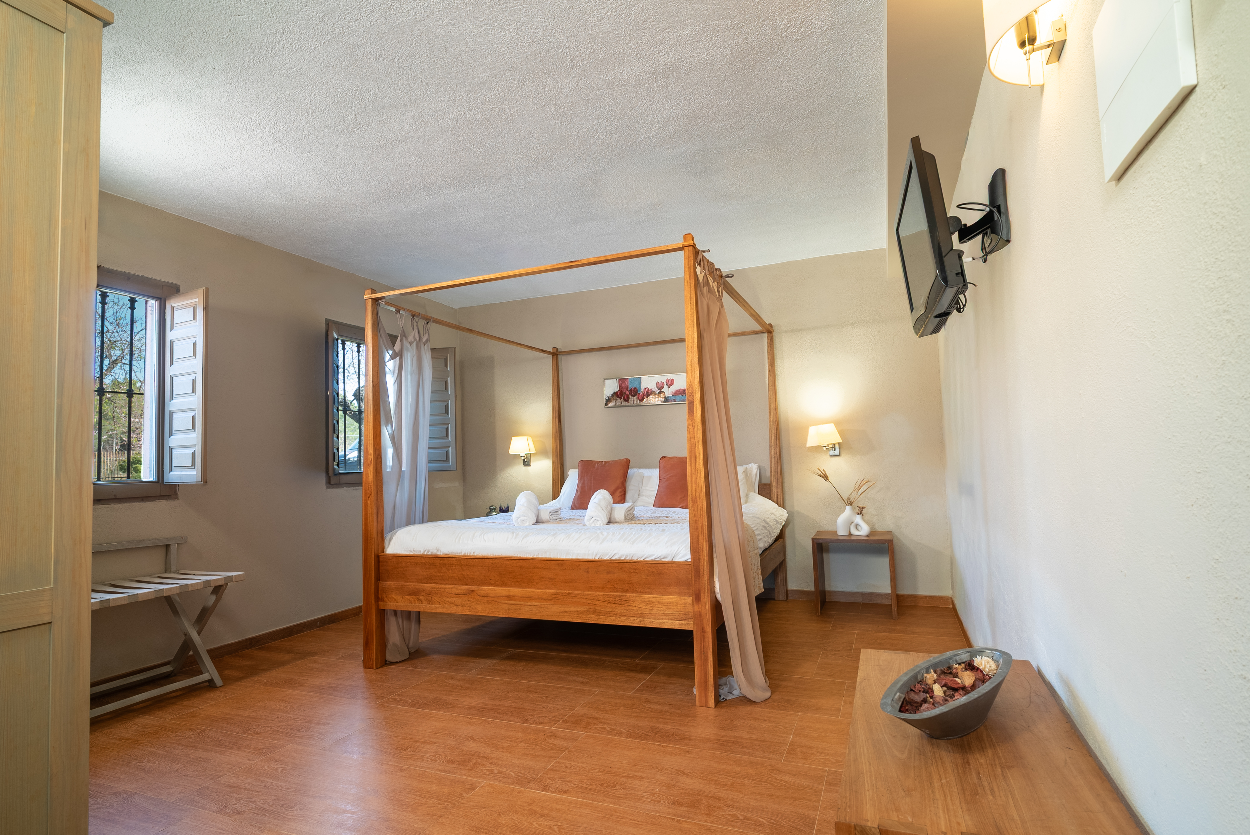 The Red Sand Suite at The Pines — four-poster bed and warm candlelit atmosphere